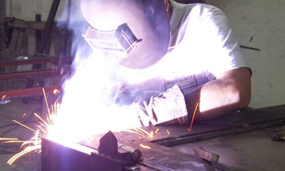 Team member custom manufacturing an iron door