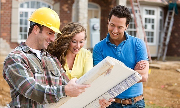 Team member homeowner and homebuilder reviewing designs together