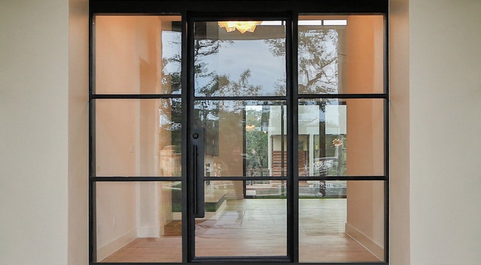 Home entrance with custom iron doors