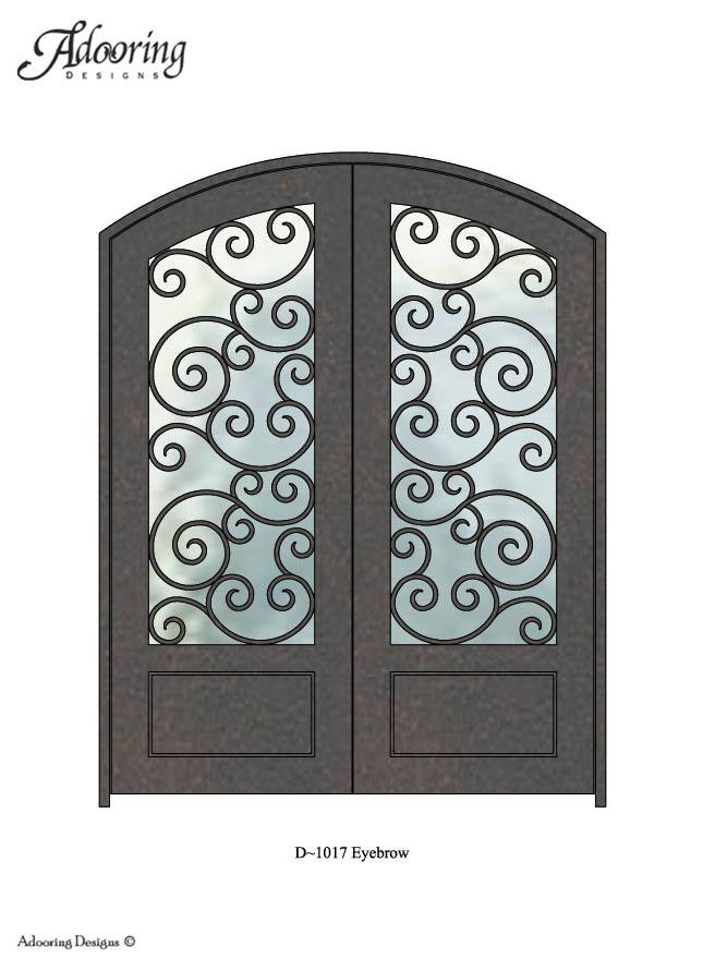 Large window in door with eyebrow top and intricate design