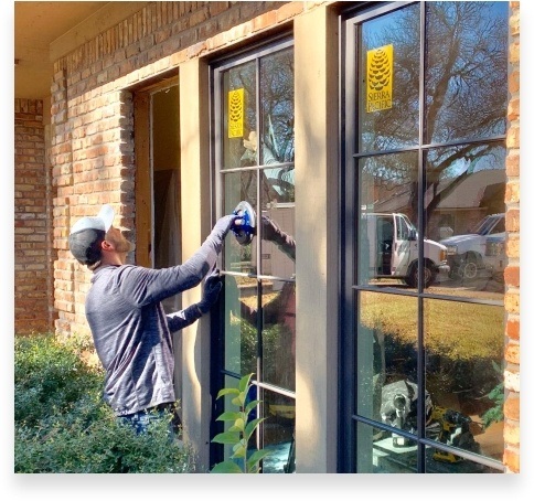 Team member installing window in Haslet home