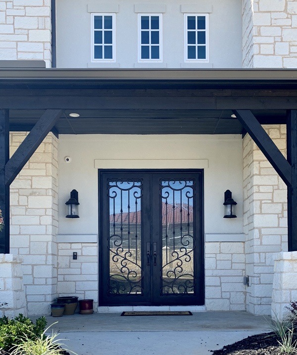 Beautiful home entrance with white brick work and iron front door