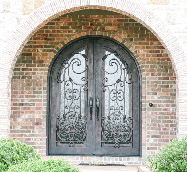 Round top double front door with intricate iron work