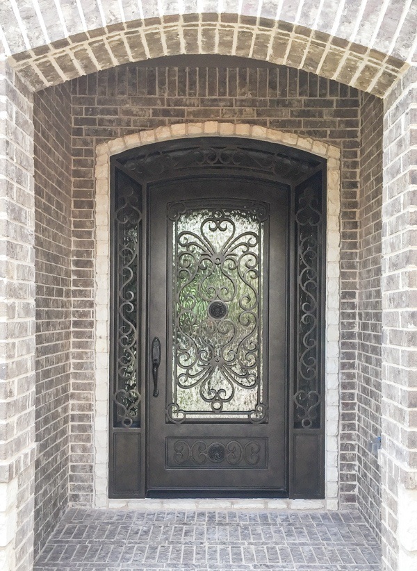 Single door with eyebrow top in bronze finish with unique designs