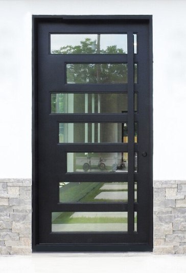 Large black finish iron front door with long thin windows of various lengths