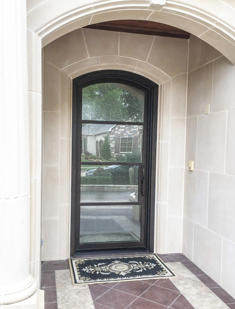 Iron front door with eyebrow top