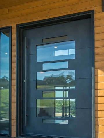 Large black finish iron door with three large windows with smaller windows between