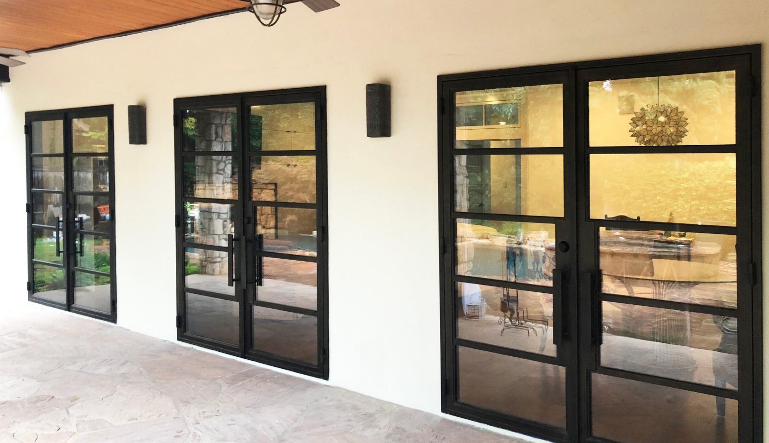 Three black finish iron double doors with square tops