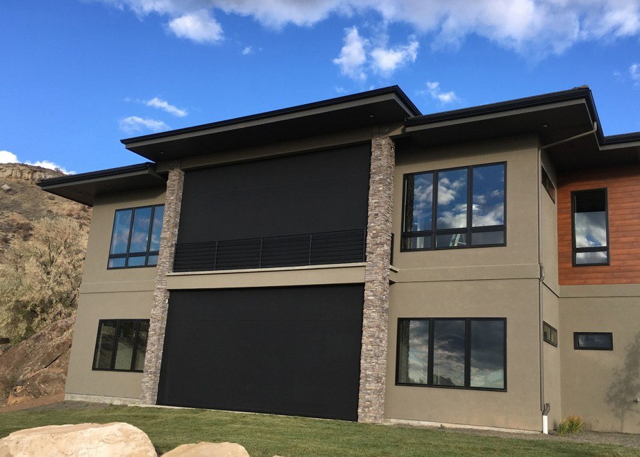 Home with patio shades enclosing patio and balcony