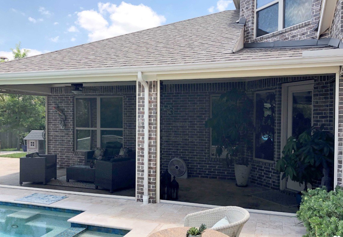 Porch enclosed on two sides with patio shades