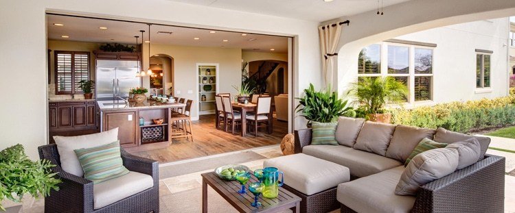 Large outdoor living room totally open to indoor kitchen through sliding glass wall
