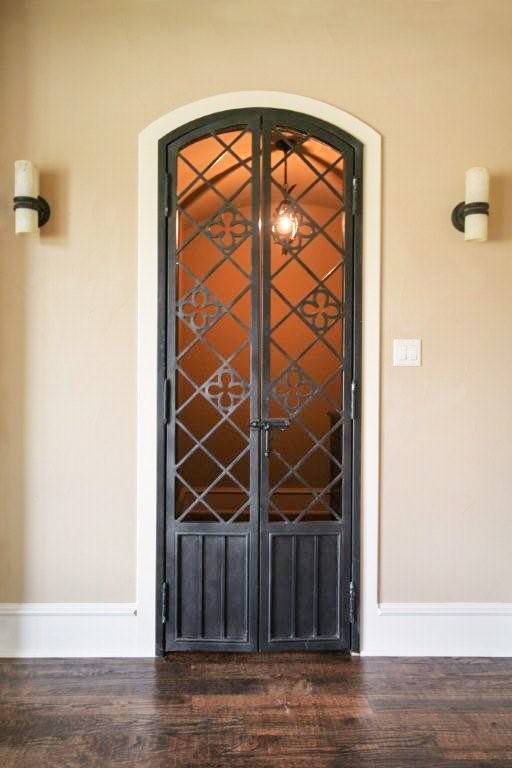 Black finish iron gate into wine cellar