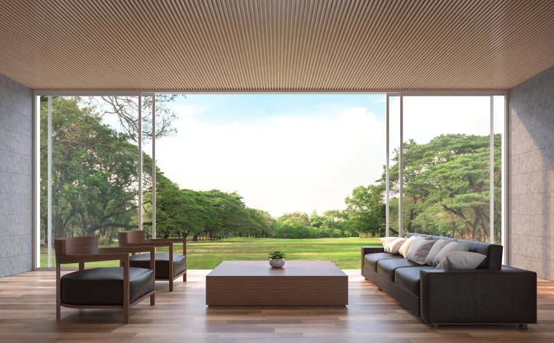 a living room area with sliding glass walls leading to the exterior of the home