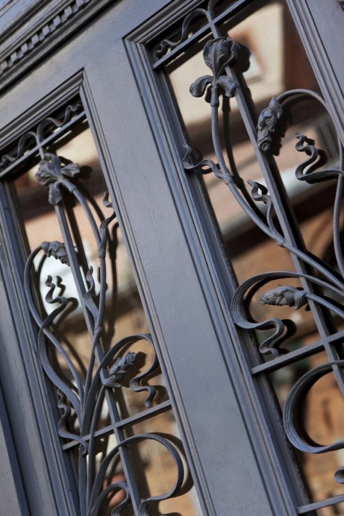An up-close image of the wrought iron design on a front door