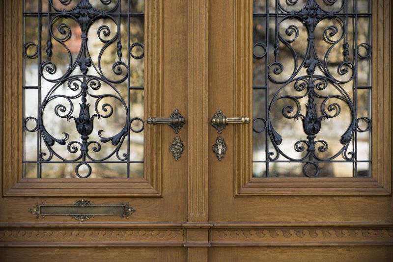 An ornate door with wrought iron design