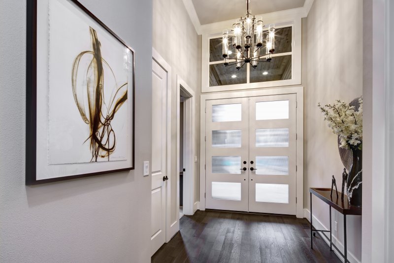 The entryway of a home with French iron doors