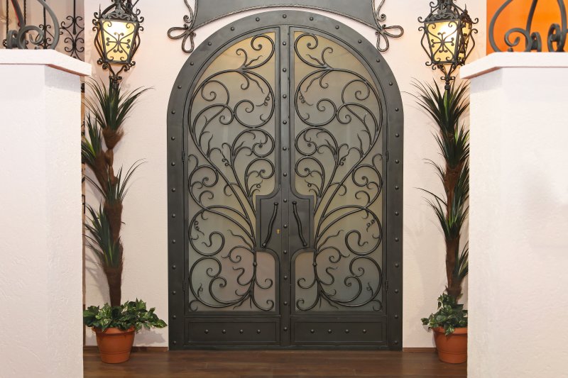 The exterior of a home with wrought iron doors