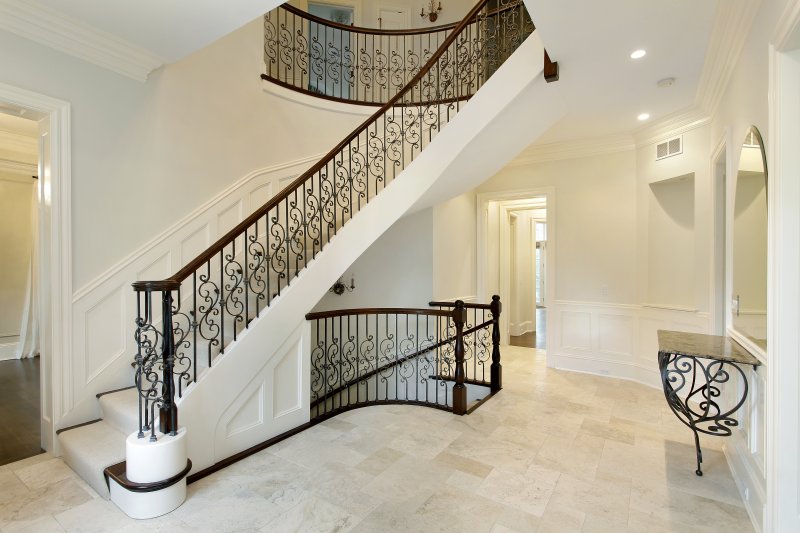 The inside of a home with a wrought-iron staircase