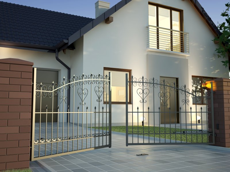 an iron gate slightly opened in front of a home