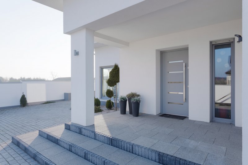 The exterior of a home and its iron door