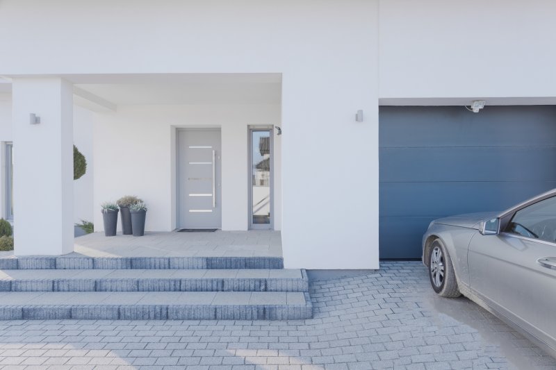 The exterior of a home and its iron door