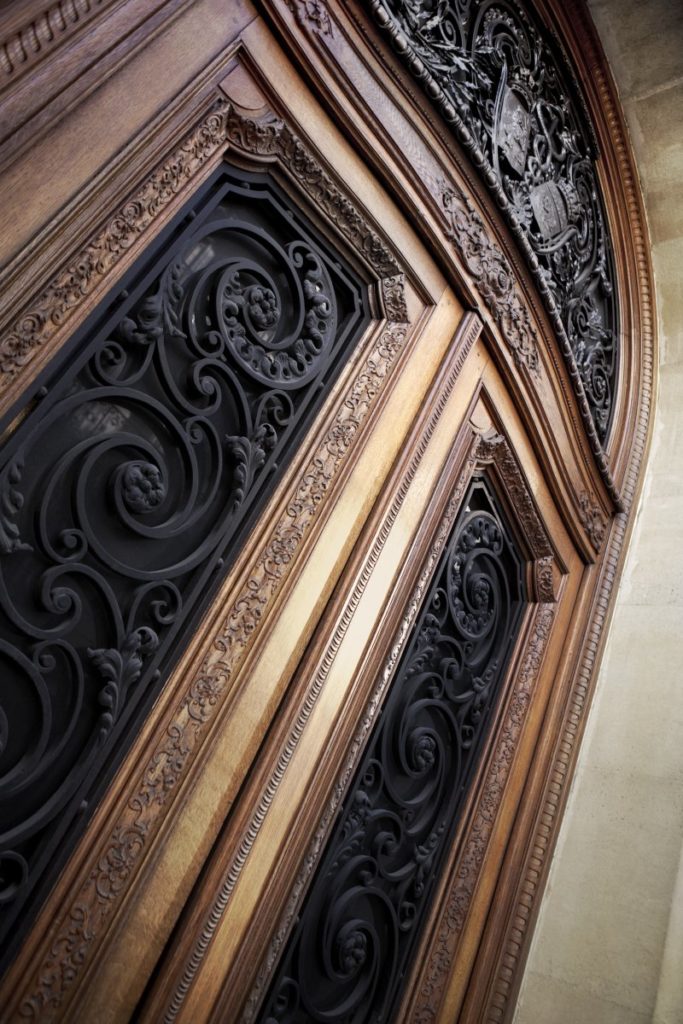 The exterior of a home and its iron door