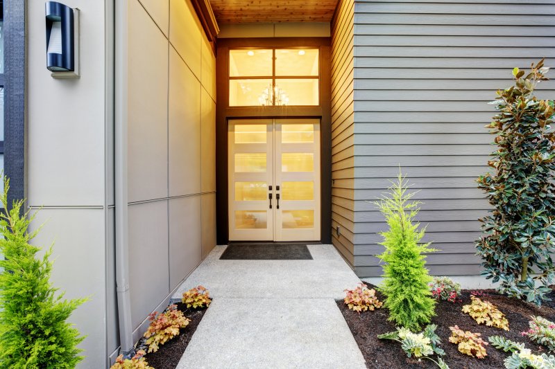 The exterior of a home and its iron door