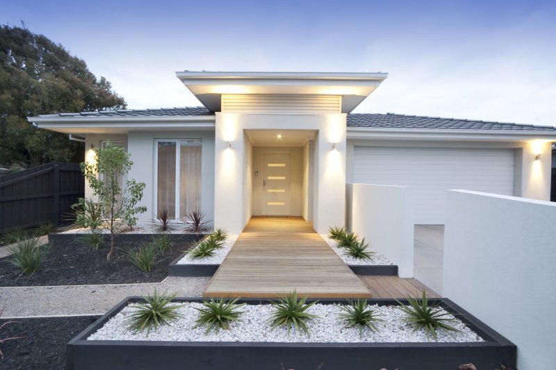 The exterior of a home and its iron door