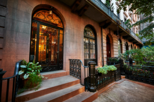 a brownstone building with an iron front door 