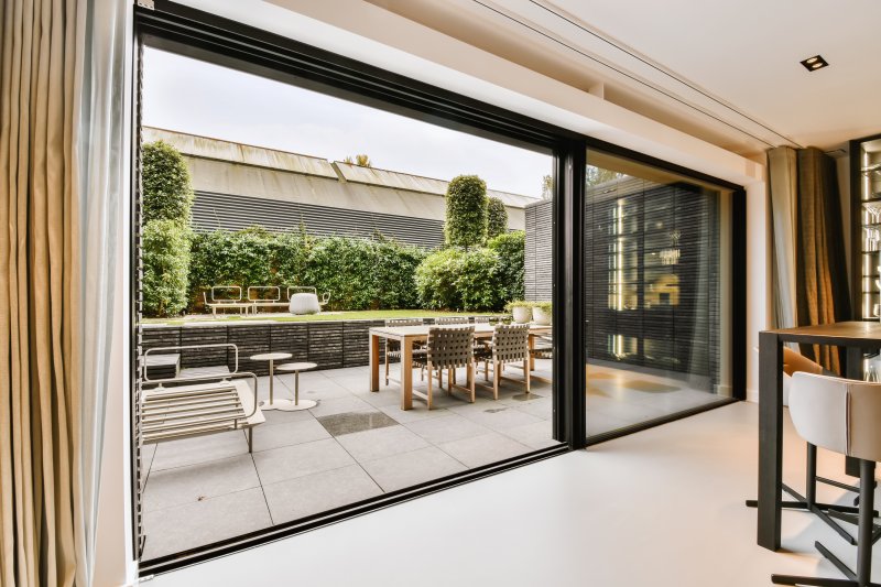 a sliding glass wall on the side of a house