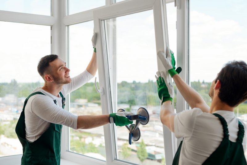 workers installing replacement windows