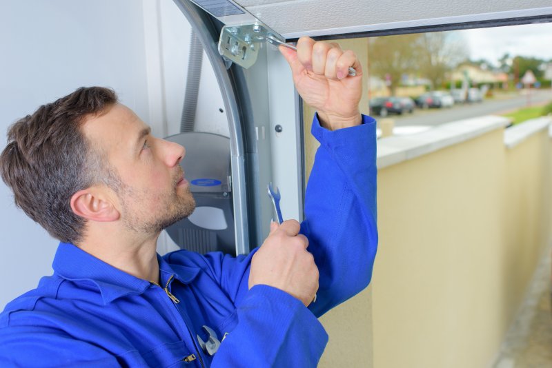 man replacing garage door 